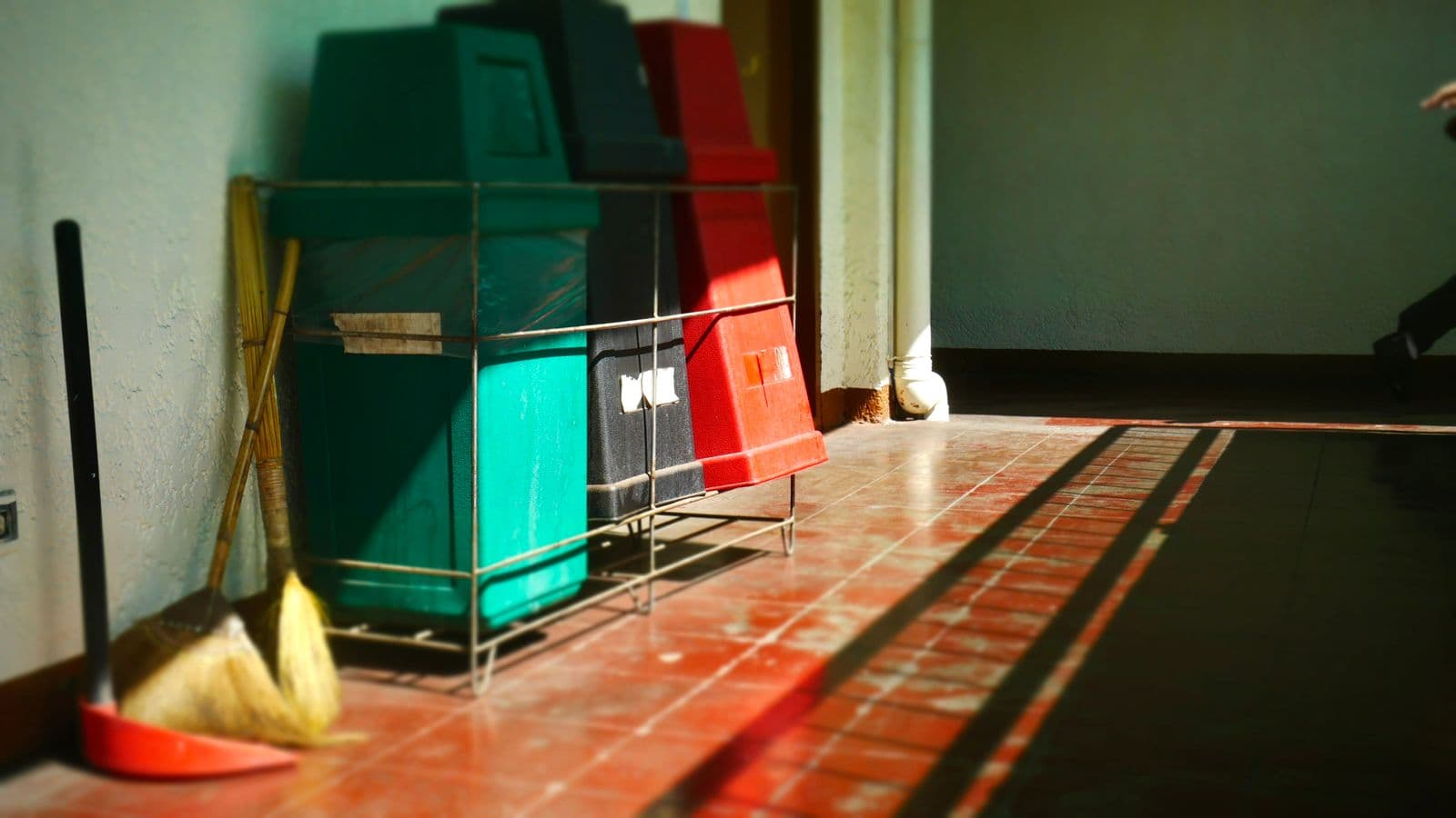 Bacs de tri alignés dans un local à déchets