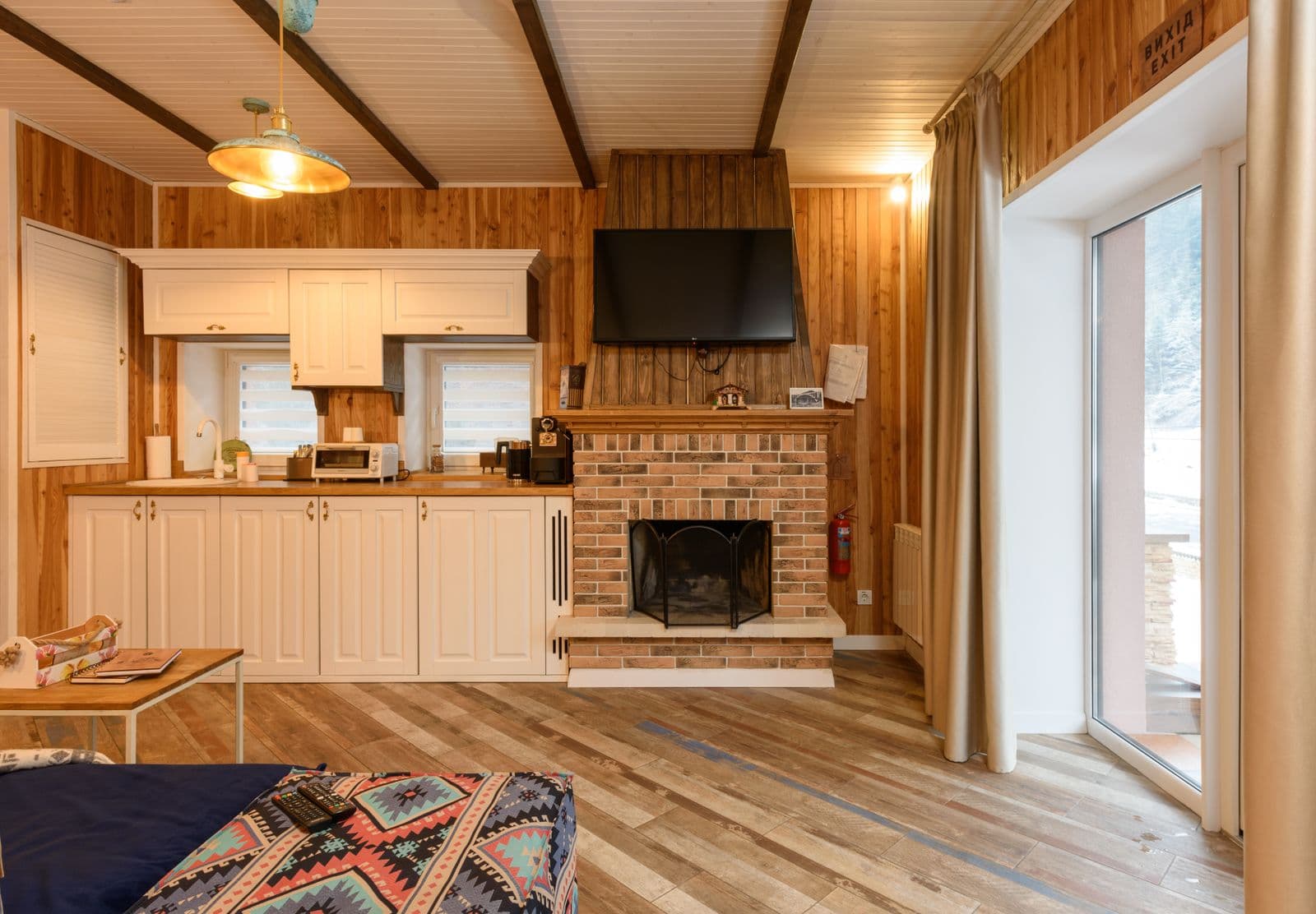 Séjour d'un chalet de montagne, cheminée et lambris de bois clair